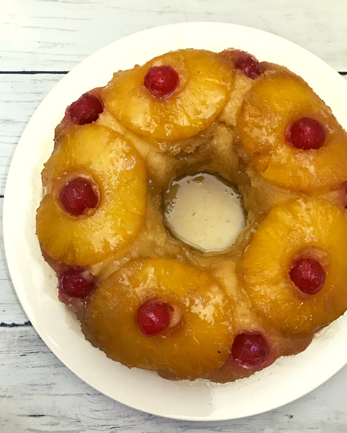 bundt pineapple upside down cake served in a white plate