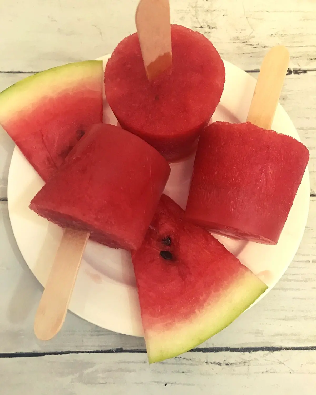 3 watermelon popsicles in a plate