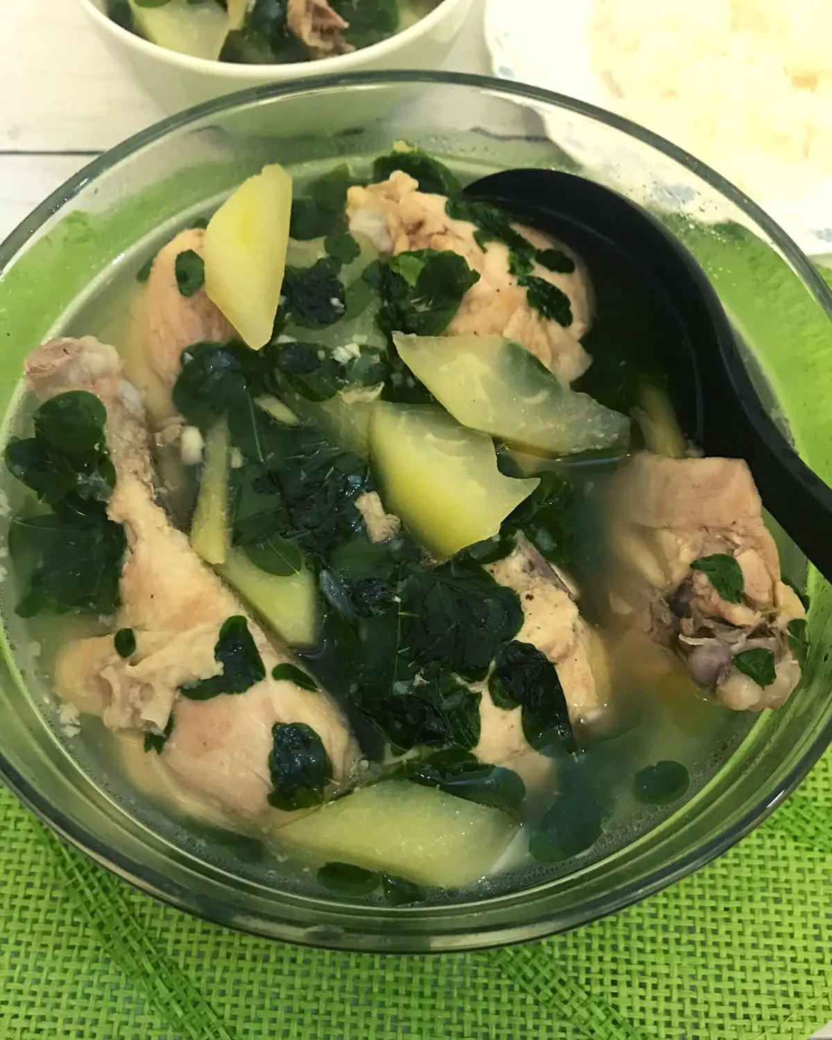 chicken tinola in a bowl with serving spoon